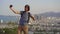 A young man tourist makes a selfie on the mountain overlooking the Nha Trang city, a famous tourist destination in