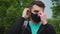 Young man tourist puts medical mask on his face for coronavirus prevention