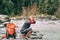 Young man tourist refresh with water in mountain river