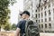 A young man or tourist or student with a backpack looks at the sights in Leipzig in Germany
