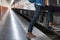 young man, tourist or traveler stepping up to the train on railway at train station. Travel, journey, trip concept