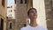 Young man tourist on a trip looks at the sights on the antique street of an ancient European city