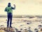 Young man with touristic suit looking on amazing seascape