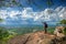 Young man traveler on cliff