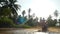 Young man traveler is driving motorbike in tropical jungle rides through a puddle. slow motion. lens flare effects