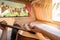 Young man traveler laying in camper van and playing guitar while road trip traveling