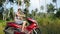 Young man traveler in sunglasses driving motorbike on tropical sunny road. slow motion. 1920x1080