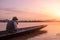 Young man traveling by boat on sunrise hour