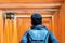 Young man traveling at Fushimi Inari taisha Shrine, happy asian traveler looking vibrant orange torii gates. landmark and popular