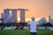 Young man traveling with hat at Sunset, solo Asian traveler visit in Singapore city downtown. landmark and popular for tourist