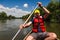 Young man travelling in a canoe