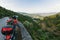 Young man travels on a motorcycle stopped at a view point and looking at the Douro Valley