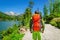 Young man trekking along mountain lake High Tatra