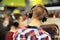 Young man in trendy checked shirt testing headphones in music tech shop. Shopping, black friday.