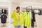 Young man tries on a semi-sheer neon jacket of fluorescent lime color in a ZARA store - Bangkok, Thailand