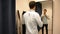 Young Man Trying on Clothes in Clothing Store