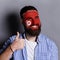 Young man with Tunis flag painted on his face