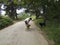 Young man with two dogs, he is petting the brown one and the black labrador is looking at them