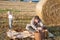 Young man and two little boys making picnic on hay field