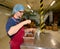 A young man unfolds chocolate mass on cups for tasting. Chocolate Factory