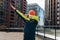 Young man in uniform shows dance movement dab, entertainment concept at the construction site