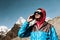 Young Man using Cell Phone in remote high Altitude Mountains toned