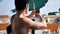 Young man using cell phone to take photo at beach