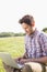 Young man using laptop in the countryside