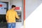 Young man using modern cash machine