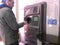 Young man using reverse vending machine