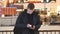 Young man using smartphone in shopping mall. Guy browsing information and scrolling pictures on smart phone. Front view