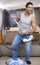 Young man using vacuum cleaner as guitar