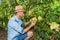 Young man, vine grower, in the vineyard.