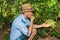 Young man, vine grower, in the vineyard.