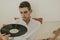 Young man with vintage music album