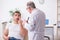 Young man visiting experienced doctor dermatologist