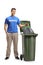 Young man volunteer throwing waste in a bin