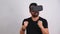 Young man in VR glasses headset gesturing excited portrait. Virtual reality, future technology, education video gaming