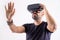 Young man in VR glasses headset gesturing portrait. Virtual reality, future technology, education video gaming