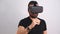 Young man in VR glasses headset gesturing scrolling portrait. Virtual reality, future technology, education video gaming