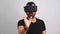 Young man in VR glasses headset gesturing scrolling portrait. Virtual reality, future technology, education video gaming