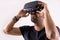 Young man in VR glasses headset holding with hands, close up portrait. Virtual reality, future technology, education