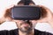 Young man in VR glasses headset holding with hands, close up portrait. Virtual reality, future technology, education