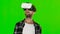 Young man with VR virtual reality headset on his head. Green screen. Close up