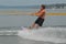 Young Man Wakeboarding and Leaning Back on the Board