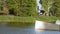Young man wakeboarding in the park making difficult pro level wakeboard tricks.