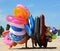 A young man walking along a beach with bunch of in