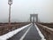 Young man walking at the Brooklyn bridge. Misty weather