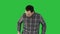 Young man walking and whistling on a Green Screen, Chroma Key.