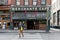 A young man walks in front of Merchants Cafe, the oldest bar in Seattle, Washington, USA.